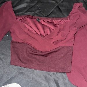 Size medium burgundy shirt see through on the arms long sleeve never worn.